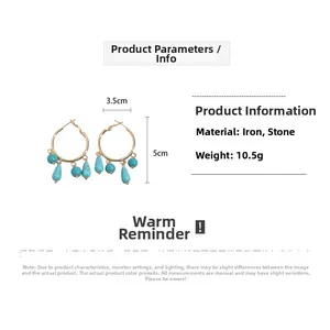 Detail view of gold hoop earrings with turquoise stones and dimensions 3.5cm by 5cm