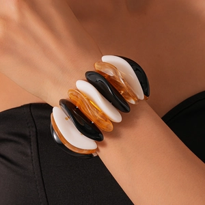 Close-up of chunky acrylic geometric stretch bracelet with marble pattern on wrist