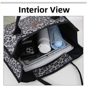 Detail view of large leopard print tote bag interior with bottle, umbrella and A4 books