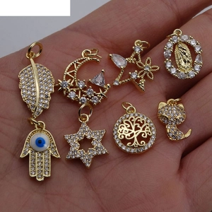 Golden micro-pave zircon charms collection with moon, star, and hand of fatima designs