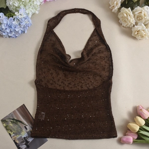 Detail of dark brown sequin knit halter top with cowl neck on floral background