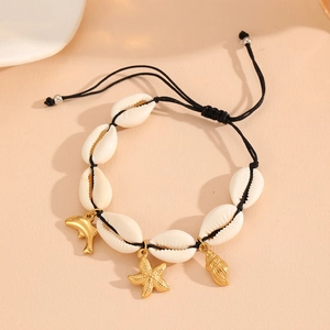 Detail of seashell bracelet with gold starfish dolphin and conch charms on black cord