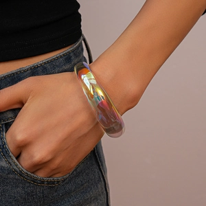 Close-up of an iridescent acrylic geometric bangle with rainbow chameleon optical effect