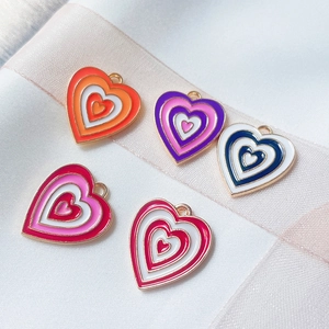 Colorful heart enamel alloy charms for DIY necklaces and earrings displayed on ribbon