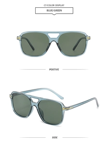 Detail of vintage square aviator sunglasses with gold T-decor and blue-green lenses