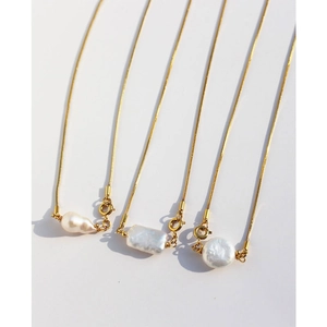 Baroque pearl pendant on gold snake bone chain with teardrop and rectangular shapes
