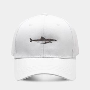Close-up of premium white cotton baseball cap featuring detailed grey shark embroidery
