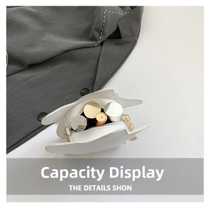 Top view of white star-shaped leather bag interior showing capacity for cosmetics