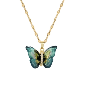Gold butterfly necklace with blue-green enamel wings and sparkling crystal accents