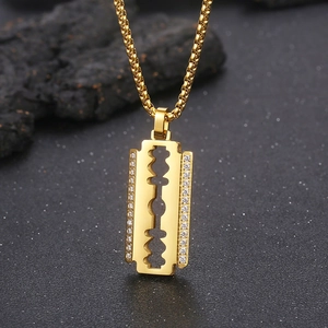 Iced out blade pendant in 18K gold plated stainless steel with shimmering black background