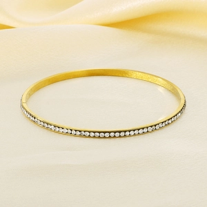 Detailed view of a 5.5mm gold titanium steel bangle fully set with sparkling rhinestones