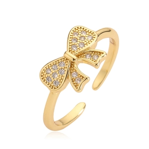 Adjustable gold bow ring featuring sparkling zircon stones for a luxury aesthetic style
