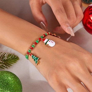 Detailed close-up of a festive beaded Christmas bracelet with snowman and tree charms