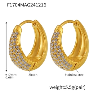 Detailed view of gold plated stainless steel huggie earrings with white zircon pavé setting