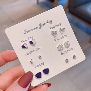Detail of 6-pair mini stud earring set with purple hearts, pearls and flowers on card