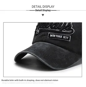 Close-up of New York City embroidery on washed black cotton baseball cap brim