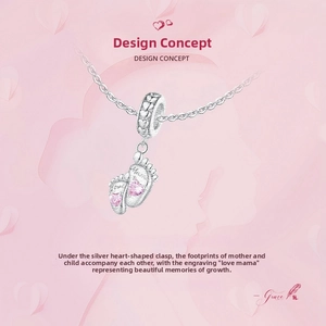 Detail of silver S925 charm featuring footprints, pink heart gem and Mama engraving