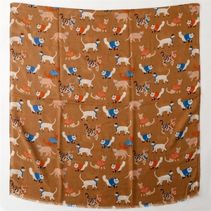 Close-up of cotton linen blend scarf with colorful cartoon cat patterns on brown fabric