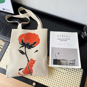 Chic knit tote bag with red cat and floral art illustration on off-white woven texture
