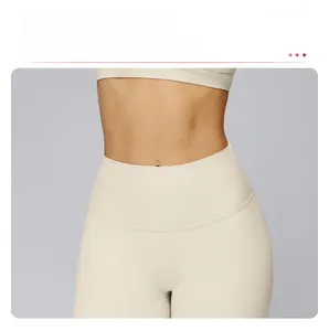 Detail of high-waist beige yoga pants featuring seamless front design and soft fabric texture