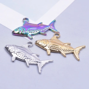 Three fish charms in gold, silver, and rainbow finishes made of 18k plated stainless steel