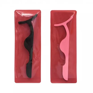 Black and pink eyelash applicator tools in plastic packaging for easy eyelash application
