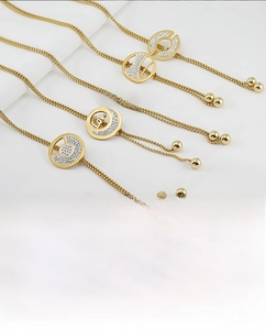 Close-up of titanium steel pendant necklaces with 18K gold plating and diamond accents