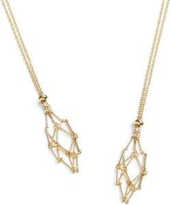 Detail of gold metal mesh cage pendant necklace with geometric hollow structure