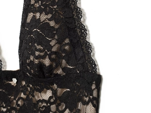Close-up of the delicate floral black lace texture and fine mesh on a slim fit backless dress