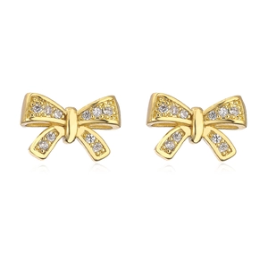 Close-up of golden bow earrings with micro-set zircon and white oil-dripped finish