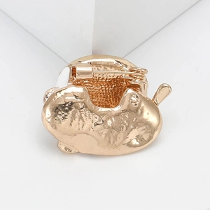 Detailed macro view of the gold alloy coffee cup brooch with secure pin back closure