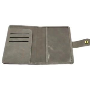 Detail view of the gray PU leather passport holder with three card slots and metal snap closure
