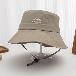 Detail of khaki outdoor bucket hat with mountain embroidery and adjustable chin strap
