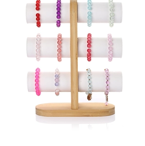 Three-tier bamboo jewelry rack with white soft bars displaying colorful beaded bracelets