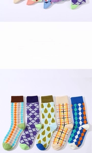 Detailed flat lay of five high-saturation plaid and geometric patterned mid-calf socks
