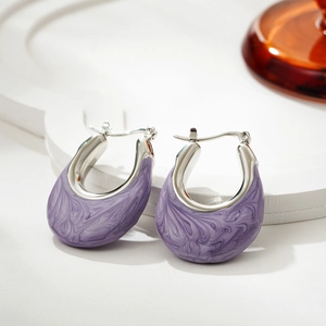 Detailed macro view of U-shaped silver earrings with purple marble enamel texture