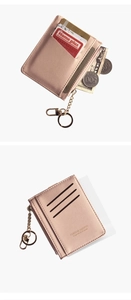 Detail of pink faux leather card holder with gold zipper, key ring and multiple slots