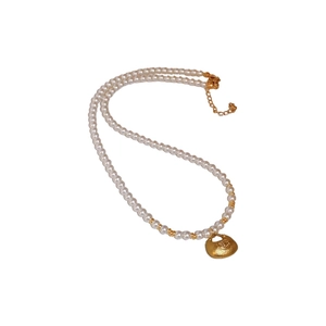 Chinese style pearl necklace with gold lucky bag pendant and bead accents on white background