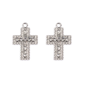 Detail view of two silver cross pendants with crystal rhinestones for jewelry making