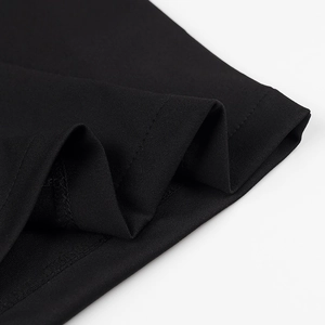 Macro detail of high-quality black knit fabric with precise double-stitching and texture
