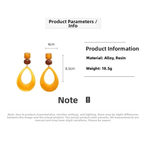 Detail view of yellow marble resin teardrop earrings with dimensions and 18.5g weight