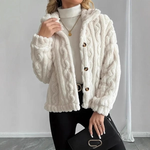 Detail view of white cable knit fleece jacket featuring textured fabric and dark buttons