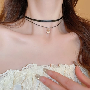 Close-up of double-layer choker necklace with a sparkling cherry rhinestone pendant