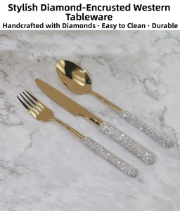 Close-up of luxury gold cutlery set with sparkling rhinestones on marble background