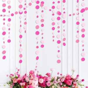 Pink paper circle garland for party backdrop decoration with floral arrangement