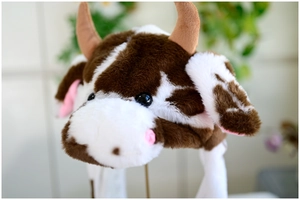 Detailed plush texture of brown and white cow hat with soft pink nose and horns