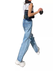 Women high-waisted wide leg distressed denim jeans in light blue featuring knee cutouts
