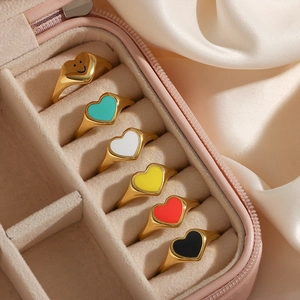 Set of 6 gold plated heart rings with colorful enamel drippings in a pink jewelry box