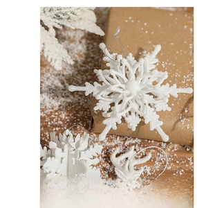 Close-up of white glittery snowflake and reindeer antler Christmas tree ornaments