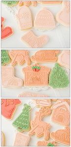 Top view of festive Christmas cookies in reindeer and house shapes with icing